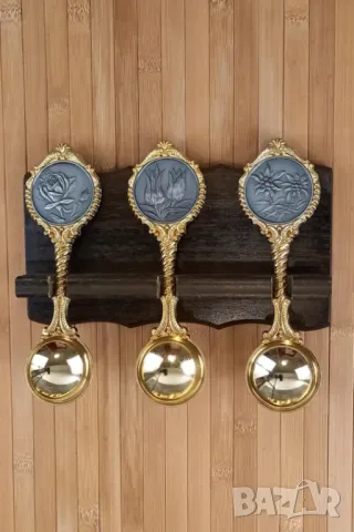 3 златисти лъжици с дървена поставка за стена