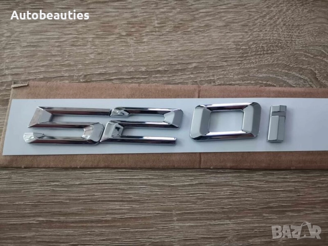 сребриста емблема BMW 520i 