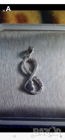 Сребърен медальон с символа на безкрайността 