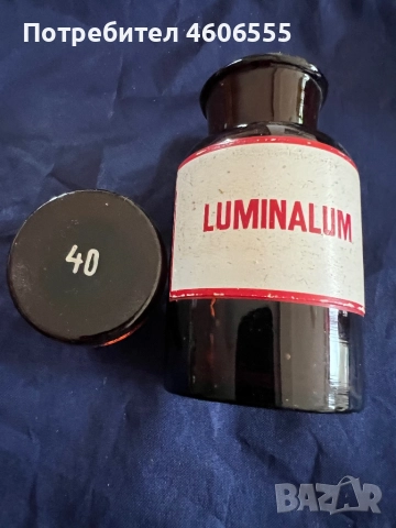 Антична аптекарска бутилка с етикет „LUMINALUM“.
