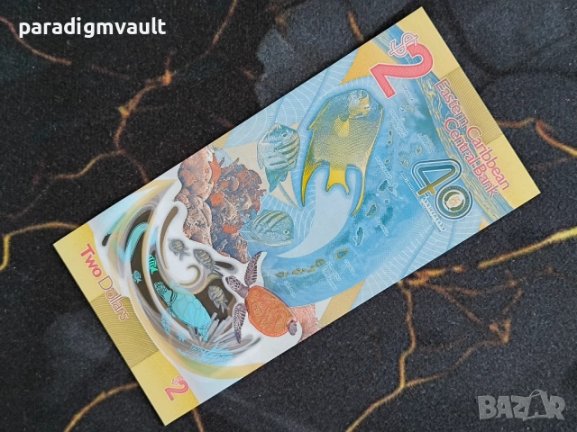 Банкнота - Източни Кариби - 2 долара (юбилейна) UNC | 2023г., снимка 2 - Нумизматика и бонистика - 53836574